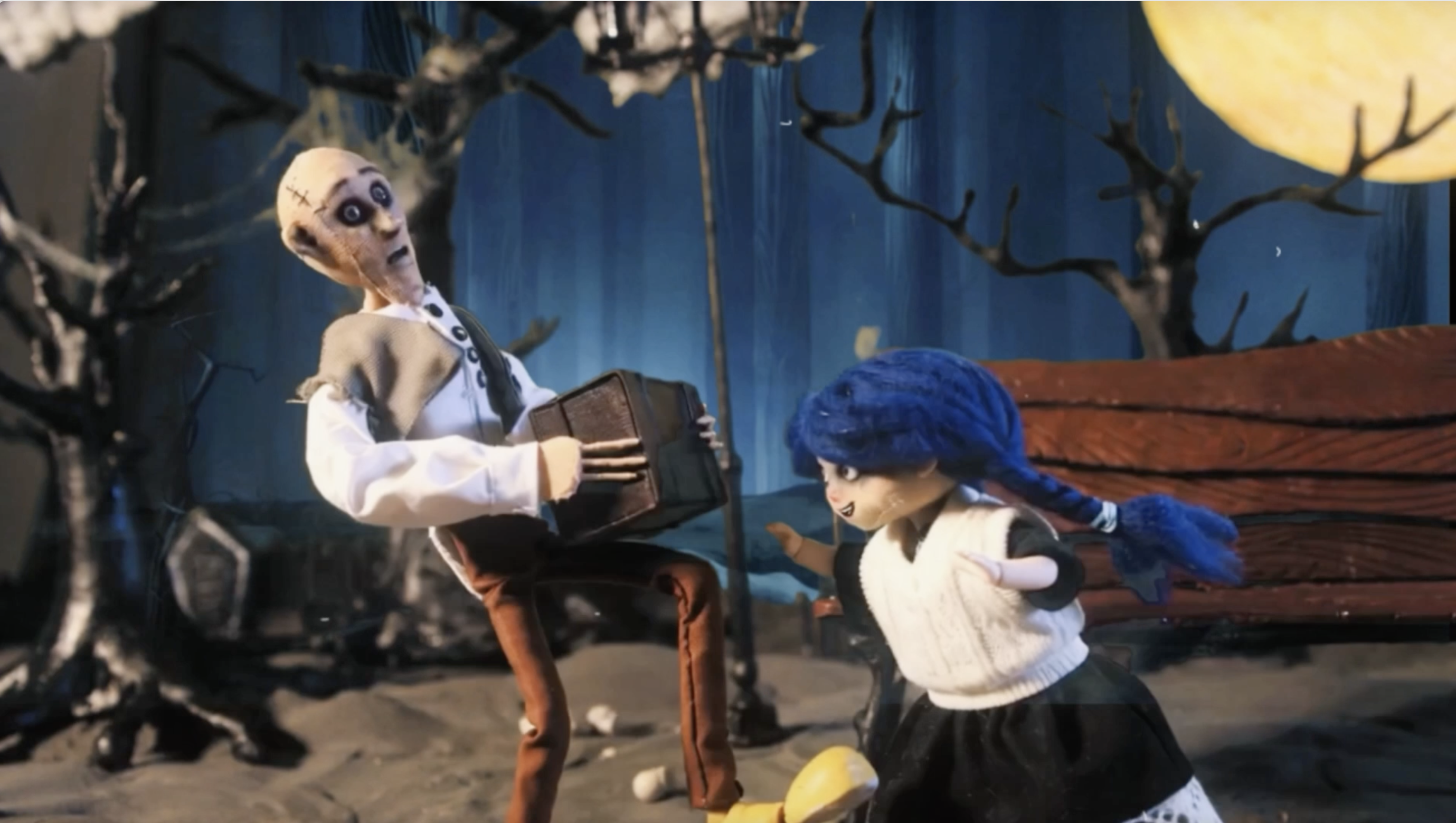 An elderly man holding a mysterious box beside a blue-haired girl in a stop-motion scene